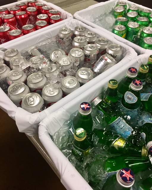 Various soft drinks chilled on ice in plastic bins. (Photo by Michael Jortner)