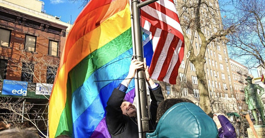 Pride flag being raised at Stonewall National Monument
